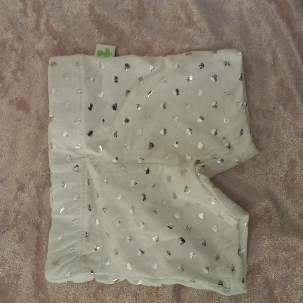 White baby shorts with sliver hearts on them